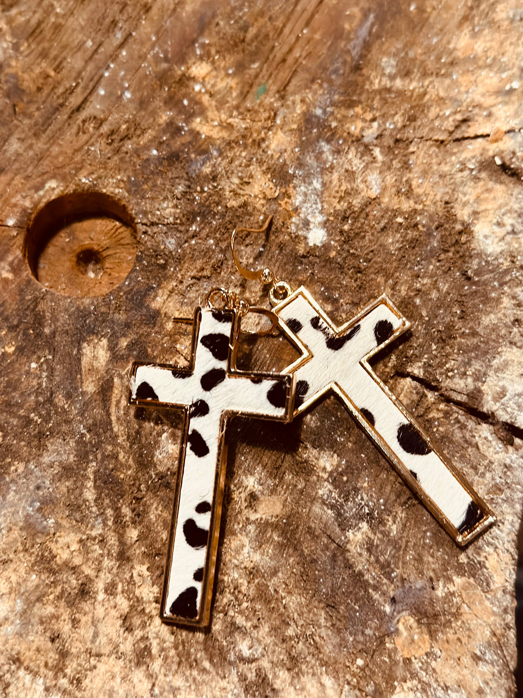 Gold encased black and white animal print cross earrings